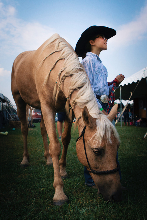 Second Place, Chuck Scott Student Photographer of the Year - Madeleine Hordinski / Ohio UniversityIrelyn Cotton, 9, poses for a portrait with her horse Charlie on Wednesday, July 10, 2019, at the Hamilton County 4-H Community Fair. Cotton braided the mane of her horse before a competition Thursday in Hamilton, Ohio.